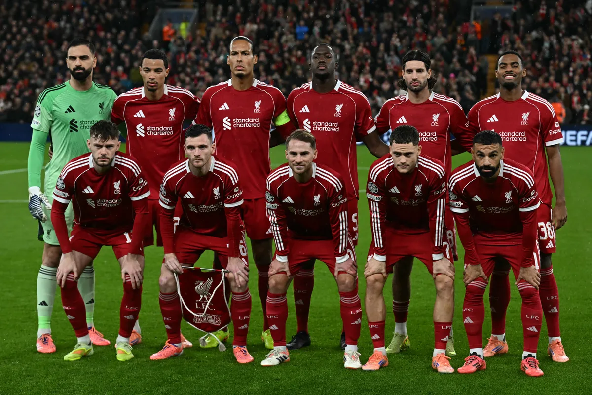(L-R back row) Liverpool's Georgian goalkeeper #25 Giorgi Mamardashvili, Liverpool's French striker #22 Hugo Ekitike, Liverpool's Dutch defender #04 Virgil van Dijk, Liverpool's French defender #05 Ibrahima Konate, Liverpool's Hungarian midfielder #08 Dominik Szoboszlai and Liverpool's Dutch midfielder #38 Ryan Gravenberch, (L-R front row) Liverpool's Northern Irish defender #12 Conor Bradley, Liverpool's Scottish defender #26 Andrew Robertson, Liverpool's Argentinian midfielder #10 Alexis Mac Allister, Liverpool's German midfielder #07 Florian Wirtz and Liverpool's Egyptian striker #11 Mohamed Salah  pose for a team photo ahead of kick-off in the UEFA Champions League, league phase football match between Liverpool and Real Madrid at Anfield in Liverpool, north west England on November 4, 2025. (Photo by Paul ELLIS / AFP)