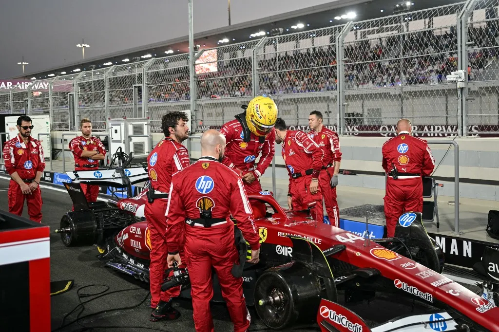 Ferrari's British driver Lewis Hamilton gets in his car before the start of the sprint race ahead of the Formula One Qatar Grand Prix at the Lusail International Circuit in Lusail on November 29, 2025. (Photo by Andrej ISAKOVIC / AFP)