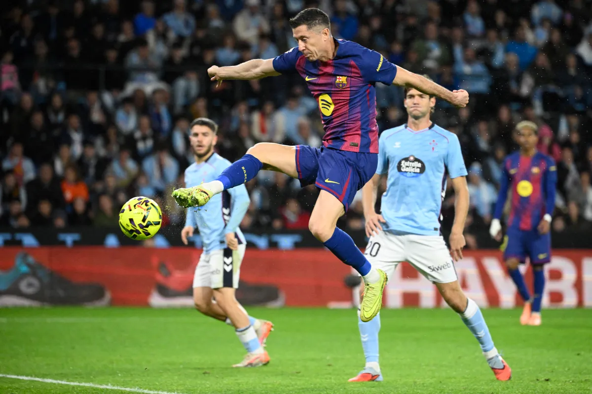 Barcelona's Polish forward #09 Robert Lewandowski scores his second goal during the Spanish league football match between RC Celta de Vigo and FC Barcelona at Balaidos Stadium in Vigo on November 9, 2025. (Photo by Miguel RIOPA / AFP)