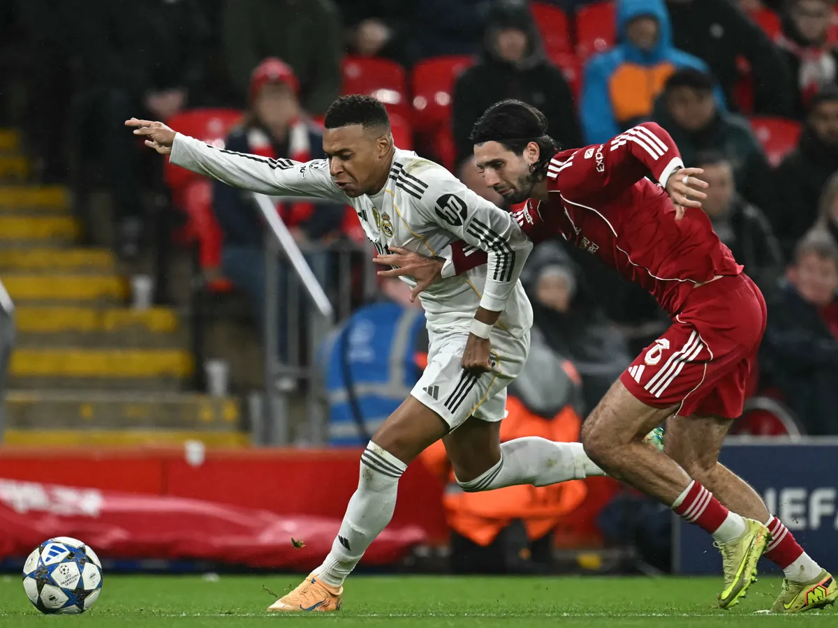 Real Madrid's French forward #10 Kylian Mbappe (L) vies with Liverpool's Hungarian midfielder #08 Dominik Szoboszlai (R) during the UEFA Champions League, league phase football match between Liverpool and Real Madrid at Anfield in Liverpool, north west England on November 4, 2025. (Photo by Paul ELLIS / AFP)