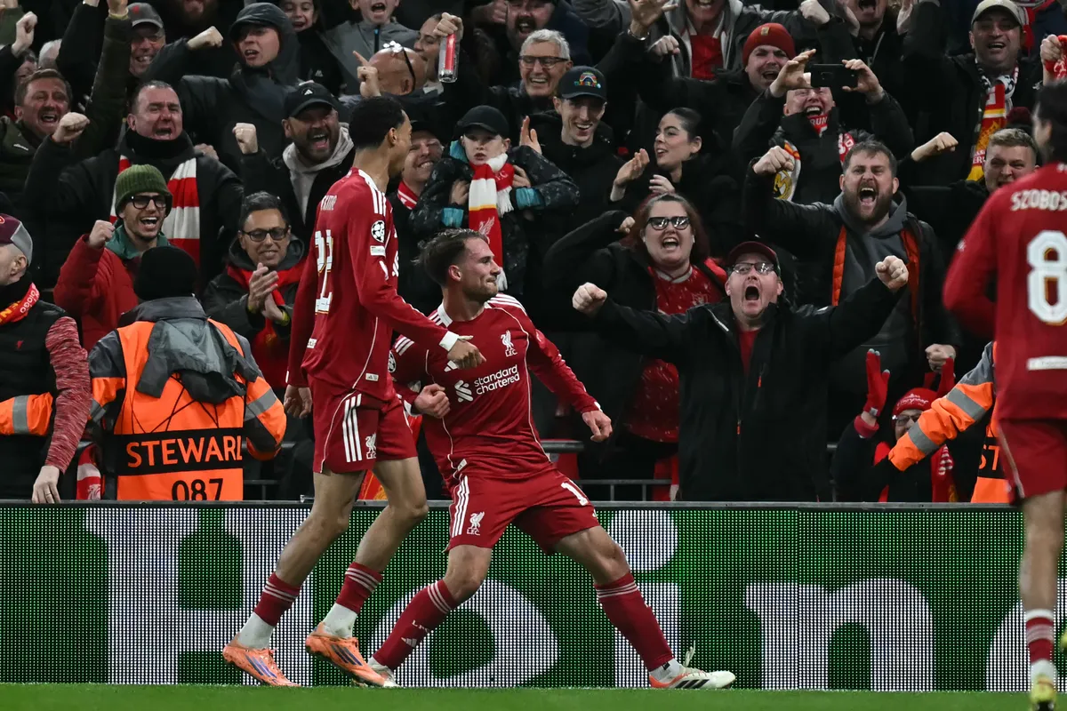 Liverpool's Argentinian midfielder #10 Alexis Mac Allister (C) celebrates after scoring the opening goal of the UEFA Champions League, league phase football match between Liverpool and Real Madrid at Anfield in Liverpool, north west England on November 4, 2025. (Photo by Paul ELLIS / AFP)