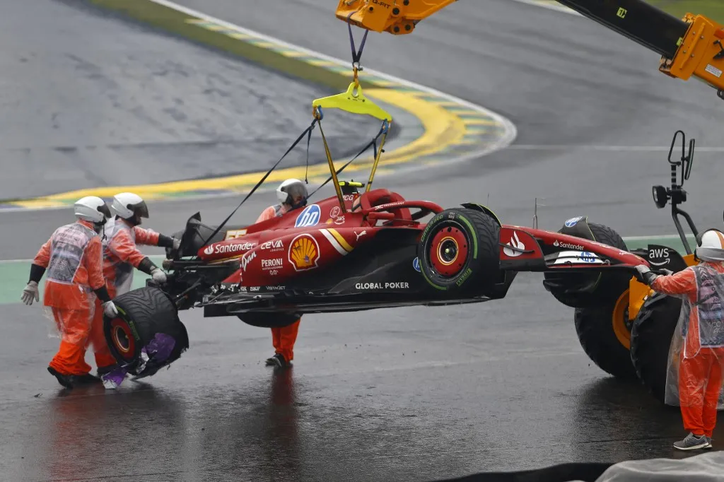 The car of Ferrari's Spanish driver Carlos Sainz is removed from the track after an accident during the qualifying session for the Formula One Sao Paulo Grand Prix, at the Jose Carlos Pace racetrack, aka Interlagos, in Sao Paulo, Brazil, on November 3, 2024. (Photo by Miguel Schincariol / AFP)