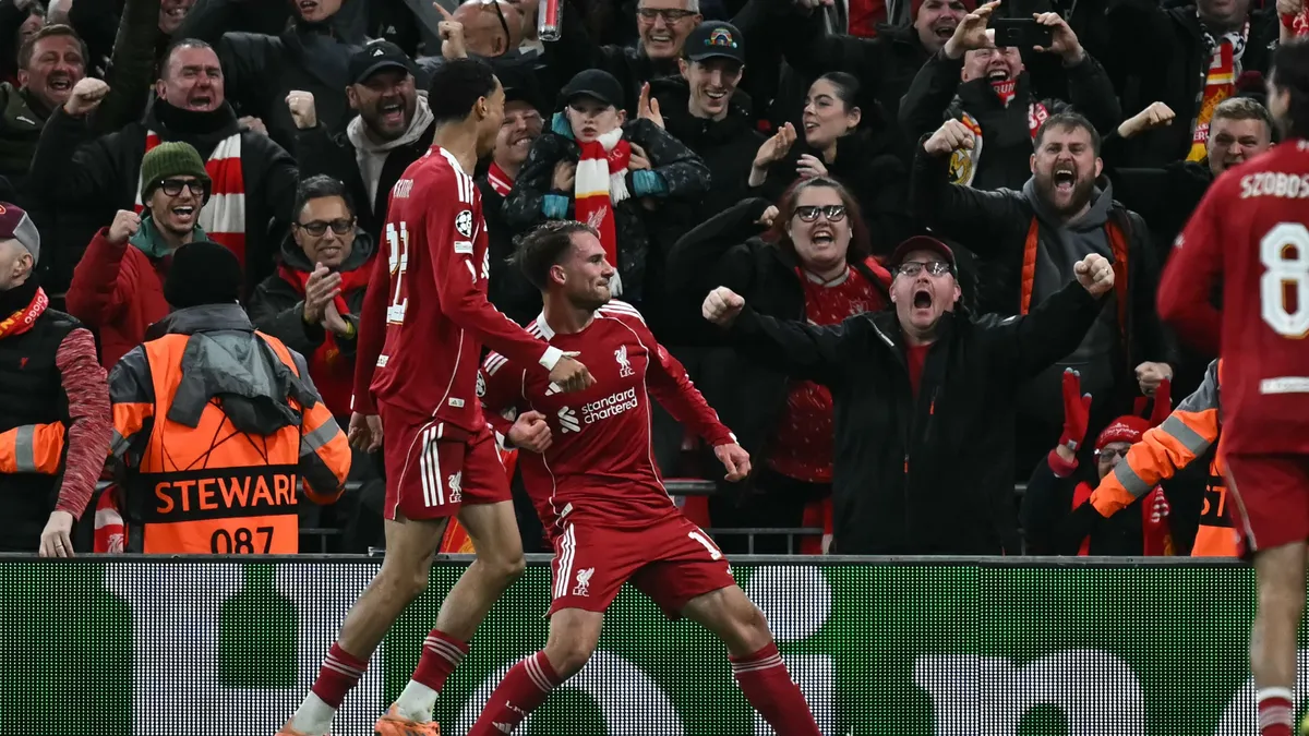 Liverpool's Argentinian midfielder #10 Alexis Mac Allister (C) celebrates after scoring the opening goal of the UEFA Champions League, league phase football match between Liverpool and Real Madrid at Anfield in Liverpool, north west England on November 4, 2025. (Photo by Paul ELLIS / AFP)