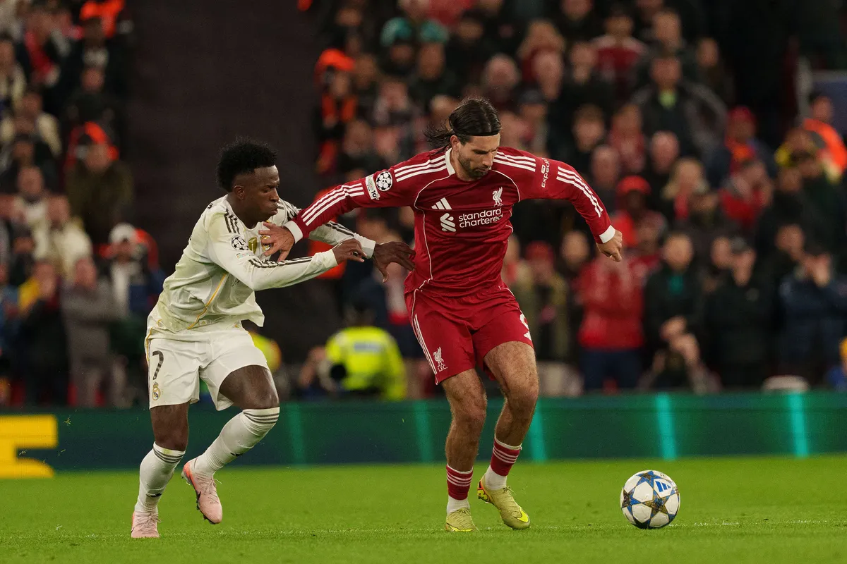 Dominik Szoboszlai of Liverpool battles with Vinicius Junior of Real Madrid during the UEFA Champions League match between Liverpool and Real Madrid at Anfield in Liverpool, England, on November 4, 2025. (Photo by Steven Halliwell/MI News/NurPhoto) (Photo by MI News / NurPhoto via AFP)