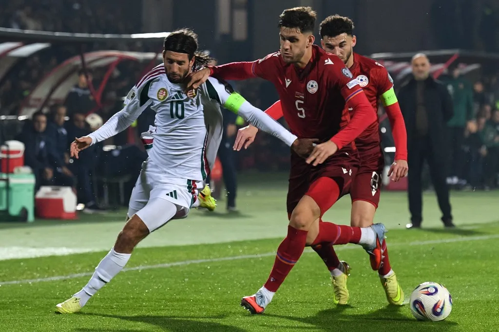 Hungary's midfielder #10 Dominik Szoboszlai and Armenia's defender #05 Styopa Mkrtchyan vie for the ball during the FIFA World Cup 2026 qualifiers Europe zone group F football match between Armenia and Hungary at the Republican Stadium after Vazgen Sargsyan in Yerevan on November 13, 2025. (Photo by KAREN MINASYAN / AFP)