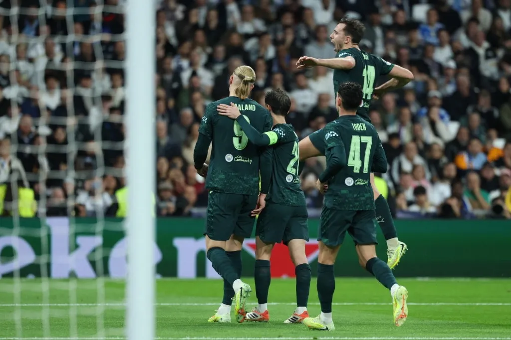 Manchester City's Norwegian forward #09 Erling Braut Haland (L) celebrates scoring his team's second goal during the UEFA Champions League league phase day 6 football match between Real Madrid CF and Manchester City at Santiago Bernabeu Stadium in Madrid on December 10, 2025. (Photo by Thomas COEX / AFP)