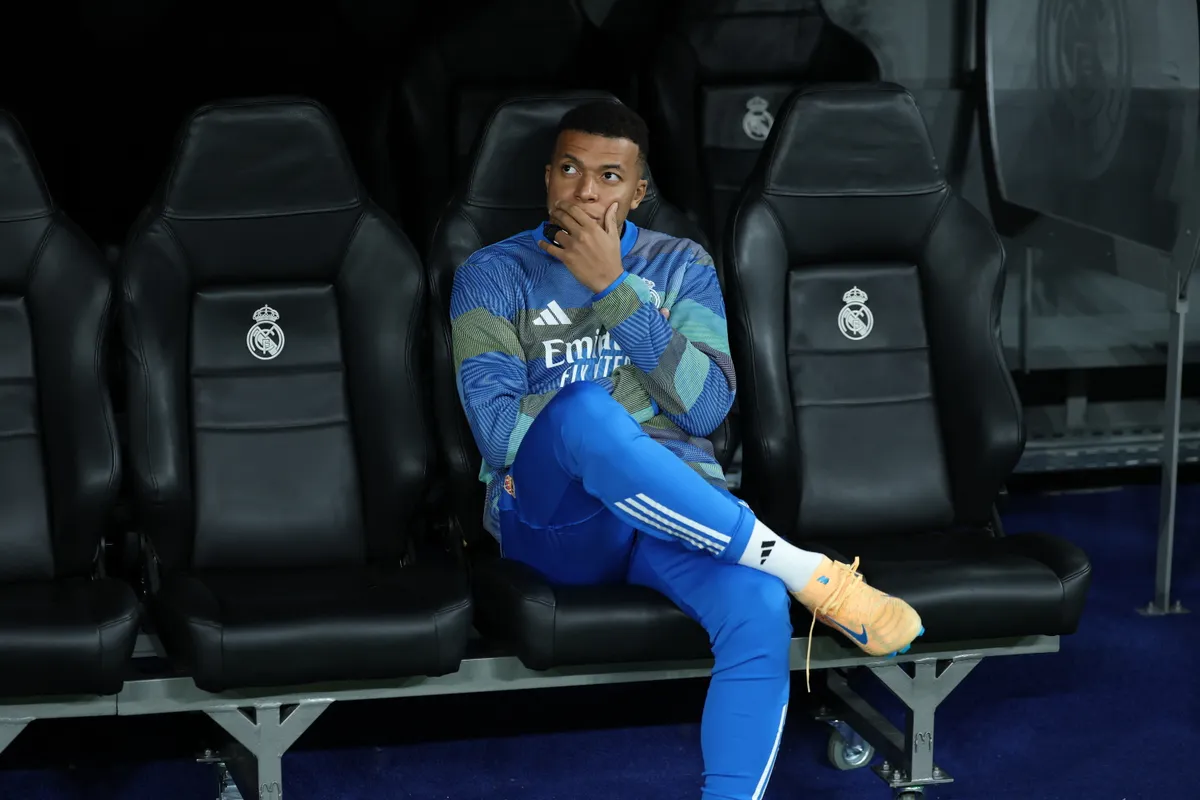 Real Madrid's French forward #10 Kylian Mbappe sits on the bench during the UEFA Champions League league phase day 6 football match between Real Madrid CF and Manchester City at Santiago Bernabeu Stadium in Madrid on December 10, 2025. (Photo by Thomas COEX / AFP)