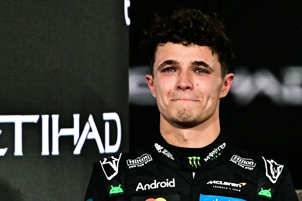 World champion and race third-placed McLaren's British driver Lando Norris reacts on the podium at the end of the Abu Dhabi Formula One Grand Prix at the Yas Marina Circuit in Abu Dhabi on December 7, 2025. (Photo by Giuseppe CACACE / AFP)