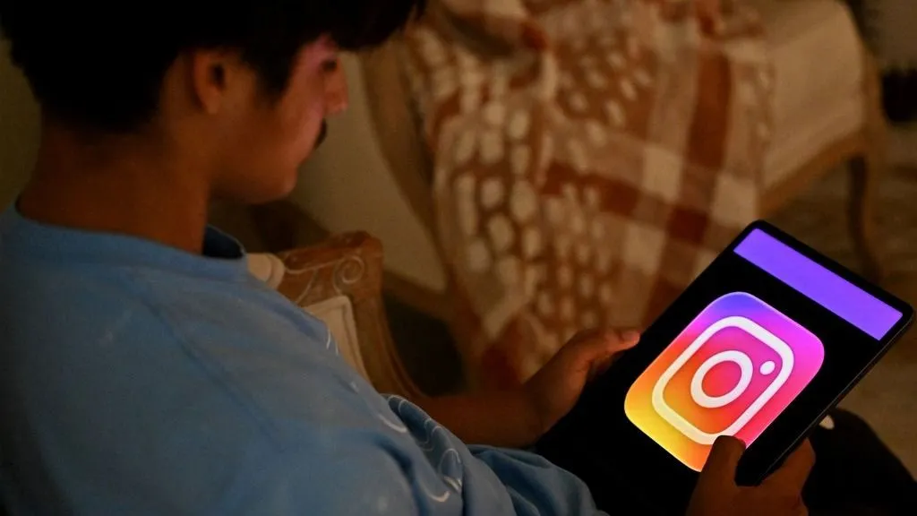 ADHD A 13-year-old boy poses at his home as he looks at social media on his tablet in Sydney on December 8, 2025. Australia will ban young teenagers from social media on December 10, 2025, launching a world-first crackdown designed to unglue children from addictive scrolling on the likes of Facebook, Instagram and TikTok. (Photo by Saeed KHAN / AFP)