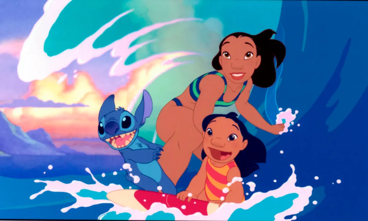 20020621;ONT;Movies;F3 -- BREAKING THE WAVES: Nani, Lilo and the strange little Stitch bond over surfing and Elvis. Caption: MO-LILO. Scenes from 2002 movie Lilo and Stitch
