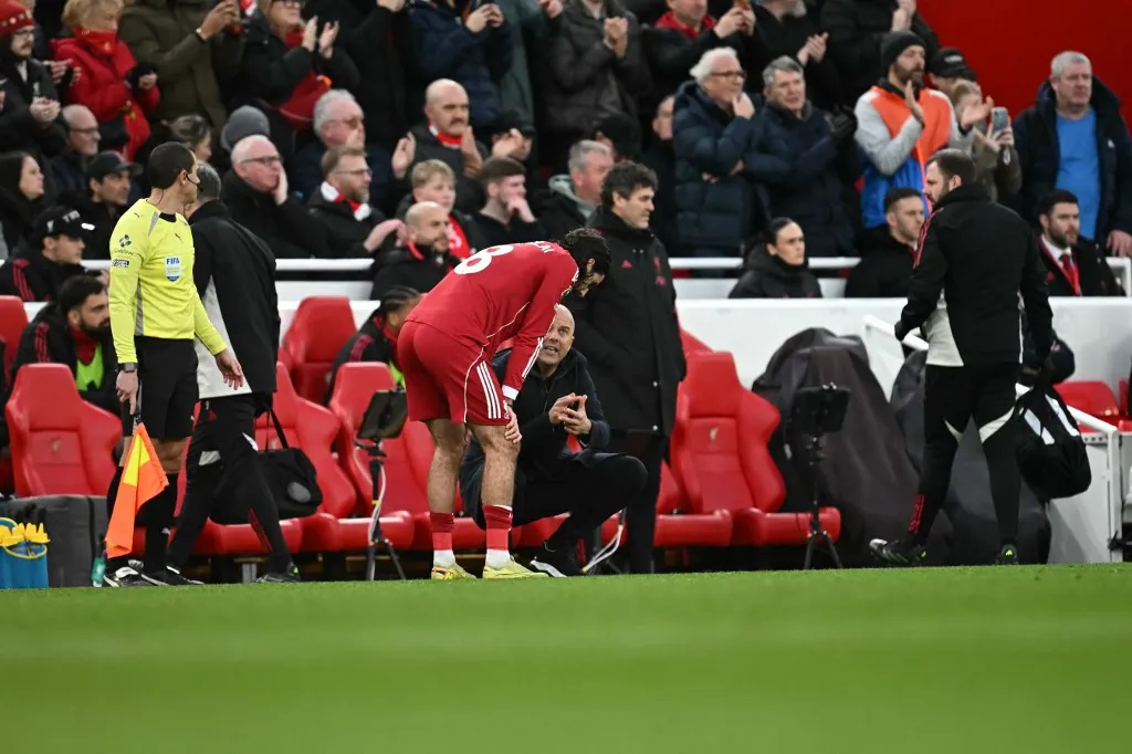 Liverpool's Dutch manager Arne Slot gives instructions to Liverpool's Hungarian midfielder #08 Dominik Szoboszlai during the English Premier League football match between Liverpool and Brighton and Hove Albion at Anfield in Liverpool, north west England on December 13, 2025. (Photo by Paul ELLIS / AFP) / RESTRICTED TO EDITORIAL USE. No use with unauthorized audio, video, data, fixture lists, club/league logos or 'live' services. Online in-match use limited to 120 images. An additional 40 images may be used in extra time. No video emulation. Social media in-match use limited to 120 images. An additional 40 images may be used in extra time. No use in betting publications, games or single club/league/player publications. / The erroneous mention[s] appearing in the metadata of this photo by Paul ELLIS has been modified in AFP systems in the following manner: [Liverpool's Dutch manager Arne Slot gives instructions to Liverpool's Hungarian midfielder #08 Dominik Szoboszlai] instead of [Liverpool's Egyptian striker #11 Mohamed Salah calls for the ball to be passed to him]. Please immediately remove the erroneous mention[s] from all your online services and delete it (them) from your servers. If you have been authorized by AFP to distribute it (them) to third parties, please ensure that the same actions are carried out by them. Failure to promptly comply with these instructions will entail liability on your part for any continued or post notification usage. Therefore we thank you very much for all your attention and prompt action. We are sorry for the inconvenience this notification may cause and remain at your disposal for any further information you may require.