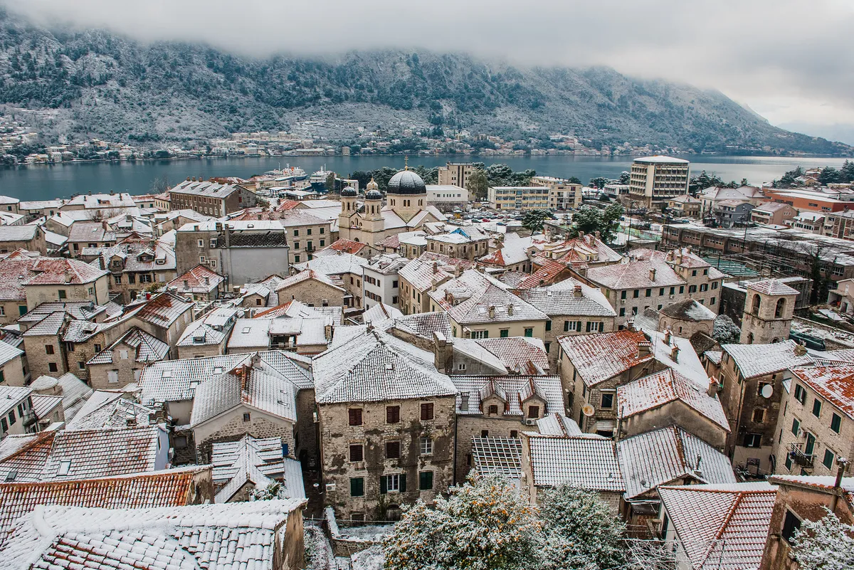 11.01.2017. Snow covering houses rooftops and buildings in Old Town Kotor, Montenegro Boka bay in cold winter