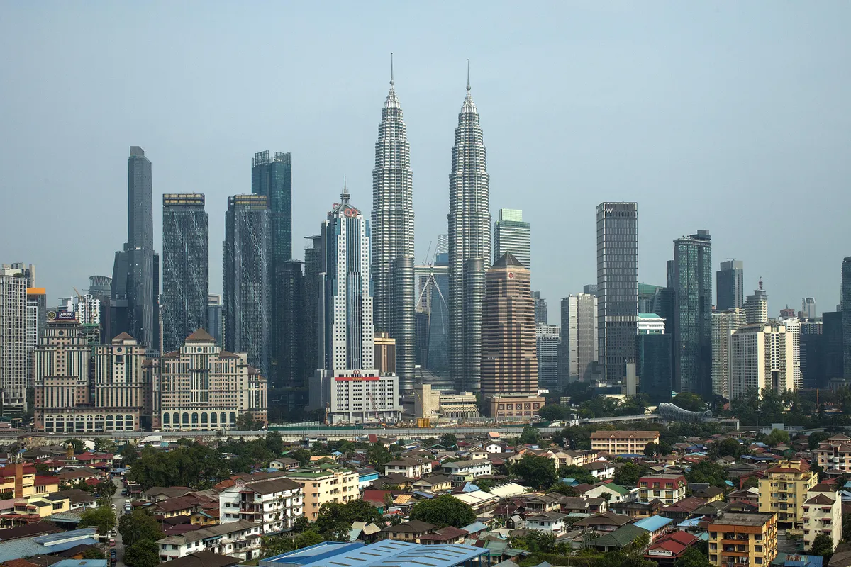 The Petronas Twin Towers, center, and other buildings in Kuala Lumpur, Malaysia, on Friday, July 25, 2025. Malaysia's economy grew faster than expected in the second quarter, driven by the services sector, even as the country contends with US President Donald Trump's rollout of global tariffs. Photographer: Samsul Said/Bloomberg via Getty Images