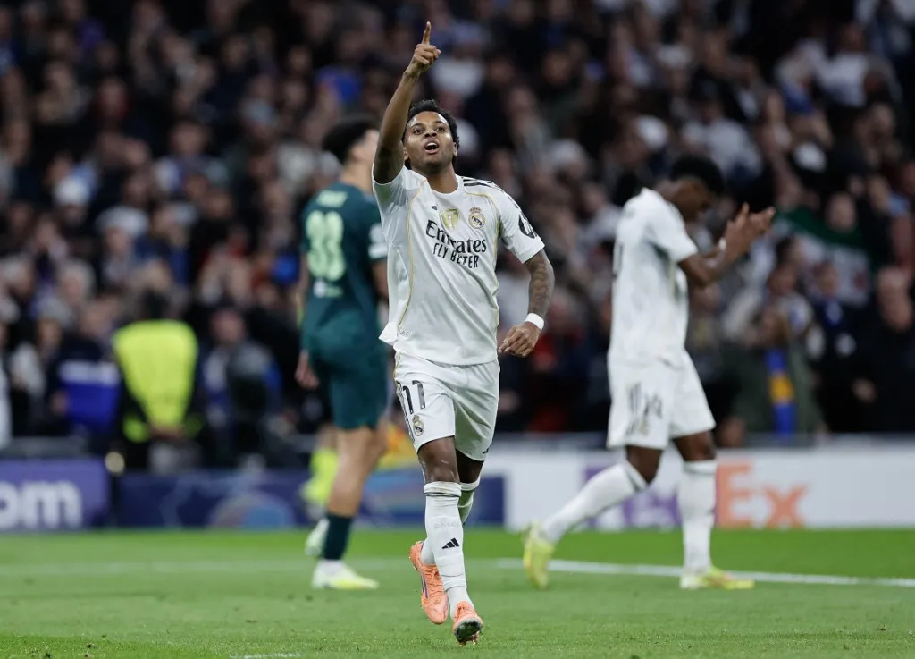 Real Madrid's Brazilian forward #11 Rodrygo celebrates scoring his team's first goal during the UEFA Champions League league phase day 6 football match between Real Madrid CF and Manchester City at Santiago Bernabeu Stadium in Madrid on December 10, 2025. (Photo by Oscar DEL POZO / AFP)