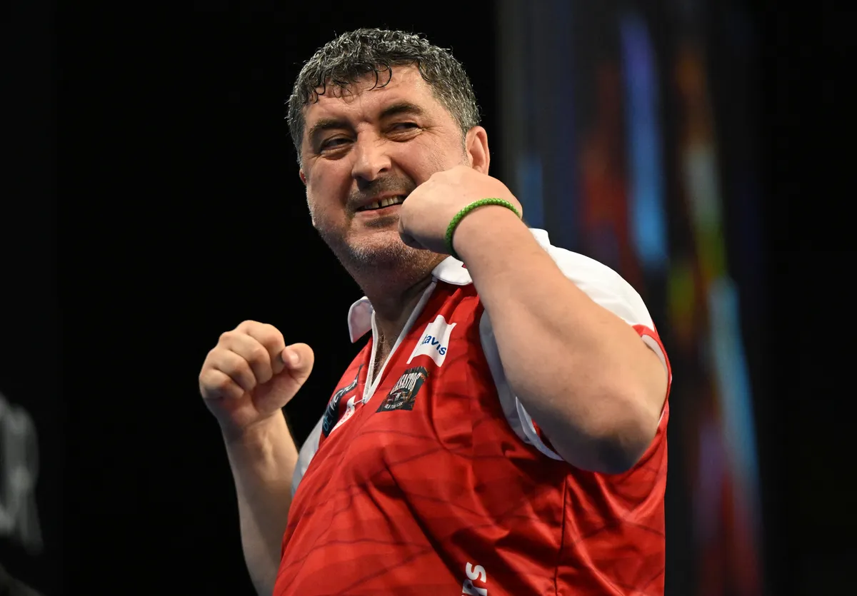 30 June 2024, Hesse, Frankfurt/Main: Darts, World Team Championship, quarter-finals, semi-finals and final, ice rink. Austria's Mensur Suljovic celebrates after a checkout in the quarter-final against Croatia. Photo: Arne Dedert/dpa (Photo by ARNE DEDERT / dpa Picture-Alliance via AFP)