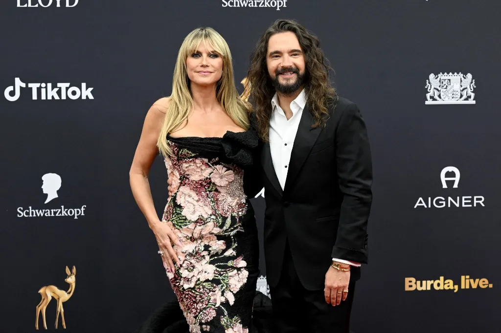13 November 2025, Bavaria, Grünwald: Heidi Klum and her husband Tom Kaulitz walk the red carpet at the 77th Bambi Awards at the Bavaria Film Studios. Photo: Felix Hörhager/dpa (Photo by Felix Hörhager / dpa Picture-Alliance via AFP)