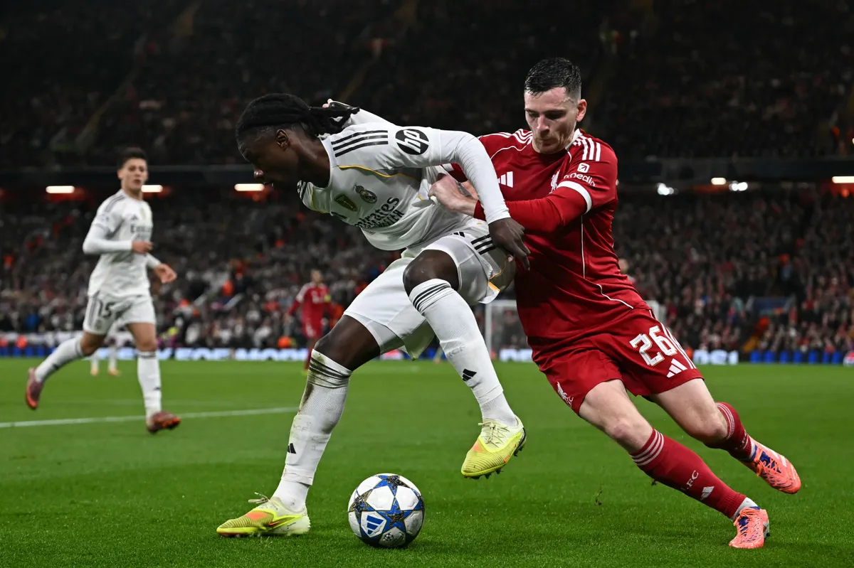 Real Madrid's French midfielder #06 Eduardo Camavinga (L) vies with Liverpool's Scottish defender #26 Andrew Robertson (R) during the UEFA Champions League, league phase football match between Liverpool and Real Madrid at Anfield in Liverpool, north west England on November 4, 2025. (Photo by Paul ELLIS / AFP)