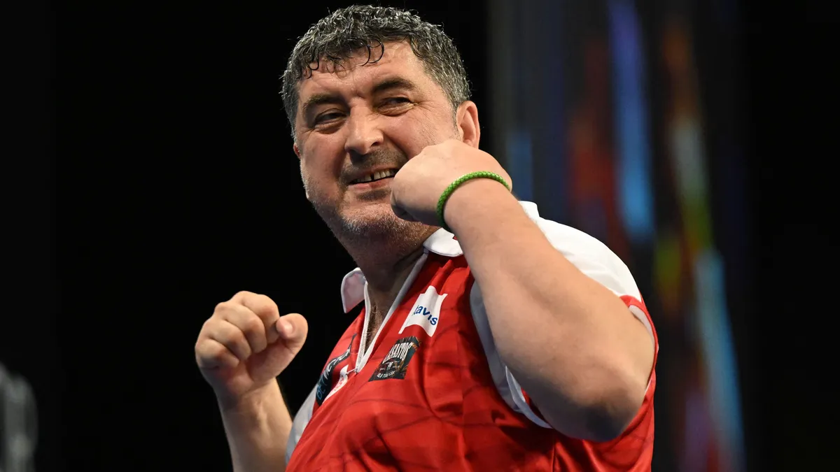 30 June 2024, Hesse, Frankfurt/Main: Darts, World Team Championship, quarter-finals, semi-finals and final, ice rink. Austria's Mensur Suljovic celebrates after a checkout in the quarter-final against Croatia. Photo: Arne Dedert/dpa (Photo by ARNE DEDERT / dpa Picture-Alliance via AFP)