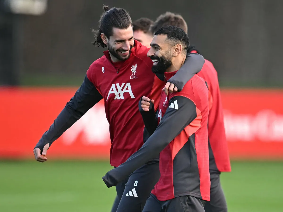 Liverpool's Hungarian midfielder #08 Dominik Szoboszlai (L) and Liverpool's Egyptian striker #11 Mohamed Salah (R) attend a team training session at their training ground in Kirkby, Liverpool, north-west England on December 8, 2025, on the eve of their UEFA Champions League, league phase football match against Inter Milan in Milan. Mohamed Salah plunged his future at Liverpool into serious doubt after claiming he had been made the fall guy for the Premier League champions' disastrous form this season. (Photo by Paul ELLIS / AFP)