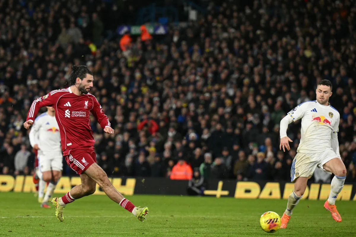 Liverpool's Hungarian midfielder #08 Dominik Szoboszlai shoots to score their third goal during the English Premier League football match between Leeds United and Liverpool at Elland Road in Leeds, northern England on December 6, 2025. (Photo by Oli SCARFF / AFP) / RESTRICTED TO EDITORIAL USE. No use with unauthorized audio, video, data, fixture lists, club/league logos or 'live' services. Online in-match use limited to 120 images. An additional 40 images may be used in extra time. No video emulation. Social media in-match use limited to 120 images. An additional 40 images may be used in extra time. No use in betting publications, games or single club/league/player publications. / 