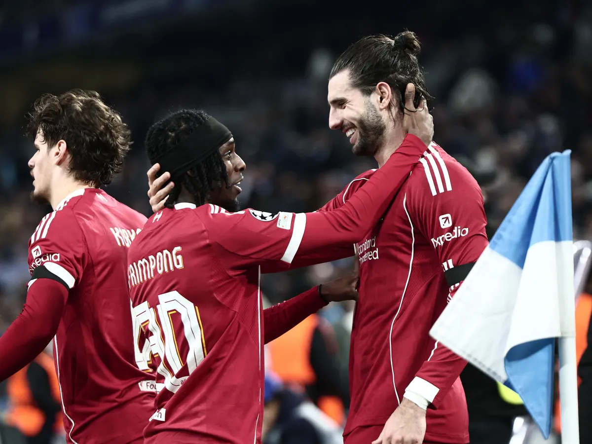Liverpool's Hungarian midfielder #08 Dominik Szoboszlai (R) celebrates with Liverpool's Dutch defender #30 Jeremie Frimpong scoring his team's first goal during the UEFA Champions League, league phase day 7, football match between Olympique de Marseille (OM) and Liverpool FC at the Stade Velodrome in Marseille, southern France, on January 21, 2026. (Photo by Thibaud MORITZ / AFP)