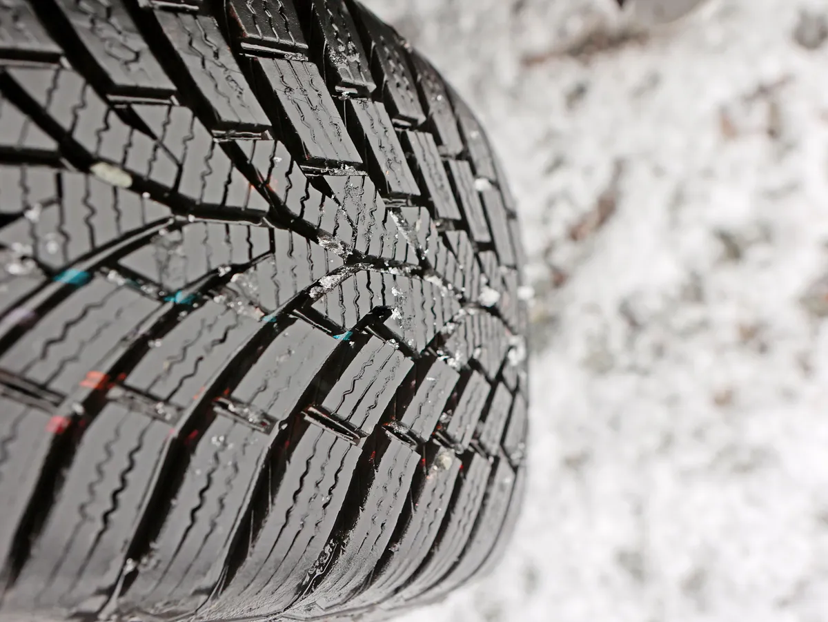 13 November 2024, Saxony-Anhalt, Schierke: The tread of a winter tire on a snow-covered road shows the road conditions in frosty temperatures. Frost and the first snowflakes are currently dominating the weather on the Brocken. Light snowfall started in the morning. The frosty temperatures are causing hoar frost. There is no change in the weather in sight for the next few days - it will remain cloudy with fog. Photo: Matthias Bein/dpa (Photo by Matthias Bein/picture alliance via Getty Images)
