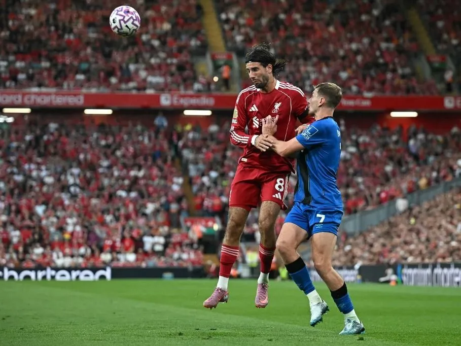Liverpool's Hungarian midfielder #08 Dominik Szoboszlai (L) vies with Bournemouth's English-born Welsh midfielder #07 David Brooks (R) during the English Premier League football match between Liverpool and Bournemouth at Anfield in Liverpool, north west England on August 15, 2025. (Photo by Paul ELLIS / AFP) / RESTRICTED TO EDITORIAL USE. No use with unauthorized audio, video, data, fixture lists, club/league logos or 'live' services. Online in-match use limited to 120 images. An additional 40 images may be used in extra time. No video emulation. Social media in-match use limited to 120 images. An additional 40 images may be used in extra time. No use in betting publications, games or single club/league/player publications. /