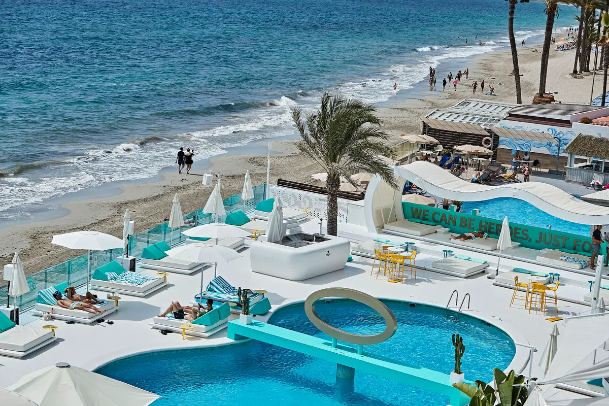 IBIZA, SPAIN - JULY 28: Clients sunbathe in the pool of the Santos hotel on the Playa D´en Bossa beach on July 28, 2020 in Ibiza, Spain. The United Kingdom, whose citizens comprise the largest share of foreign tourists in Spain, added Ibiza and other Spanish islands to its advice against non-essential travel to the country, citing a rise in coronavirus cases. The change follows the UK's decision to reimpose a 14-day isolation period for travelers returning from Spain. (Photo by Andres Iglesias/Getty Images)