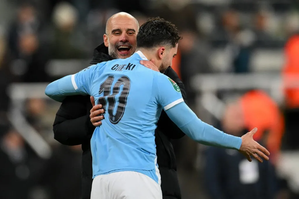 Pep Guardiola, manager of Manchester City, is happy for Rayan Cherki of Manchester City after he comes on and scores City's second goal during the Carabao Cup Semi-Final First Leg match between Newcastle United and Manchester City at St. James's Park in Newcastle, England, on January 13, 2026. (Photo by Scott Llewellyn/MI News/NurPhoto) (Photo by MI News / NurPhoto via AFP)