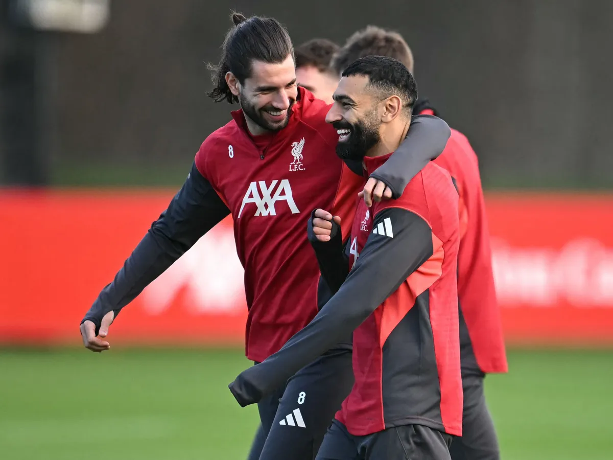 Liverpool's Hungarian midfielder #08 Dominik Szoboszlai (L) and Liverpool's Egyptian striker #11 Mohamed Salah (R) attend a team training session at their training ground in Kirkby, Liverpool, north-west England on December 8, 2025, on the eve of their UEFA Champions League, league phase football match against Inter Milan in Milan. Mohamed Salah plunged his future at Liverpool into serious doubt after claiming he had been made the fall guy for the Premier League champions' disastrous form this season. (Photo by Paul ELLIS / AFP)