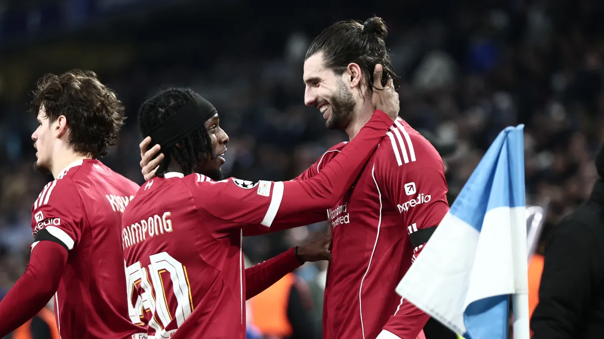 Liverpool's Hungarian midfielder #08 Dominik Szoboszlai (R) celebrates with Liverpool's Dutch defender #30 Jeremie Frimpong scoring his team's first goal during the UEFA Champions League, league phase day 7, football match between Olympique de Marseille (OM) and Liverpool FC at the Stade Velodrome in Marseille, southern France, on January 21, 2026. (Photo by Thibaud MORITZ / AFP)
