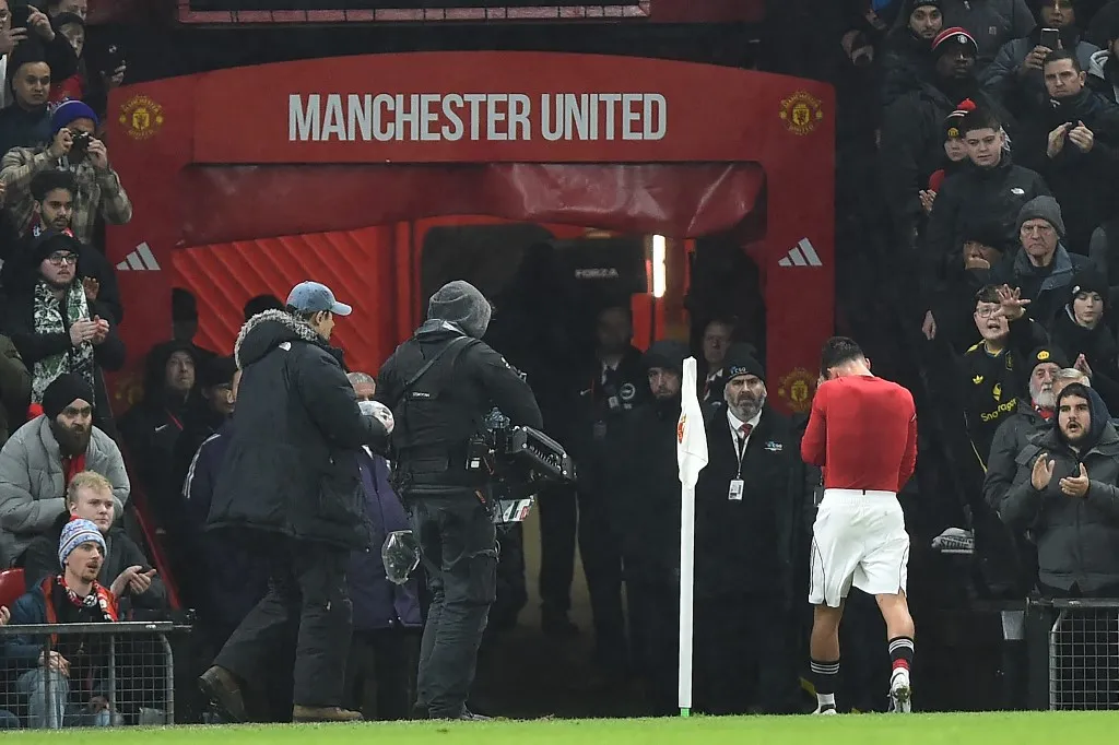 Manchester United's English midfielder #61 Shea Lacey walks down the tunnel having been sent off during the English FA Cup third round football match between Manchester United and Brighton and Hove Albion at Old Trafford Stadium in Manchester, north west England, on January 11, 2026. (Photo by PETER POWELL / AFP) / RESTRICTED TO EDITORIAL USE. No use with unauthorized audio, video, data, fixture lists, club/league logos or 'live' services. Online in-match use limited to 120 images. An additional 40 images may be used in extra time. No video emulation. Social media in-match use limited to 120 images. An additional 40 images may be used in extra time. No use in betting publications, games or single club/league/player publications. / 