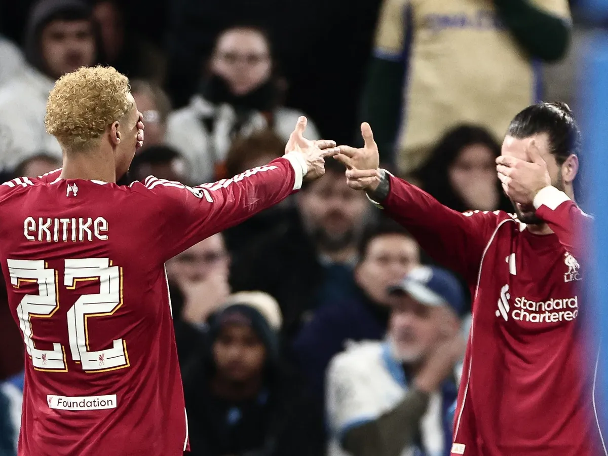 Liverpool's French forward #22 Hugo Ekitike (L) celebrates scoring a goal that was later disallowed during the UEFA Champions League, league phase day 7, football match between Olympique de Marseille (OM) and Liverpool FC at the Stade Velodrome in Marseille, southern France, on January 21, 2026. (Photo by Thibaud MORITZ / AFP)