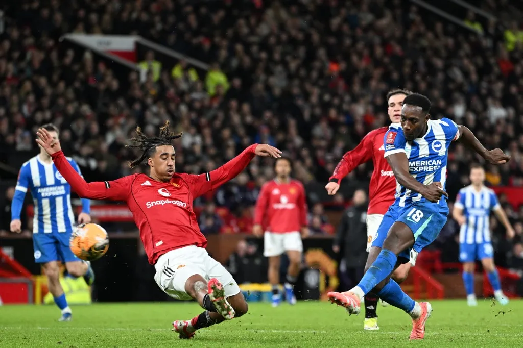 Brighton's English striker #18 Danny Welbeck (R) shoots to score their second goal during the English FA Cup third round football match between Manchester United and Brighton and Hove Albion at Old Trafford Stadium in Manchester, north west England, on January 11, 2026. (Photo by PETER POWELL / AFP) / RESTRICTED TO EDITORIAL USE. No use with unauthorized audio, video, data, fixture lists, club/league logos or 'live' services. Online in-match use limited to 120 images. An additional 40 images may be used in extra time. No video emulation. Social media in-match use limited to 120 images. An additional 40 images may be used in extra time. No use in betting publications, games or single club/league/player publications. / 