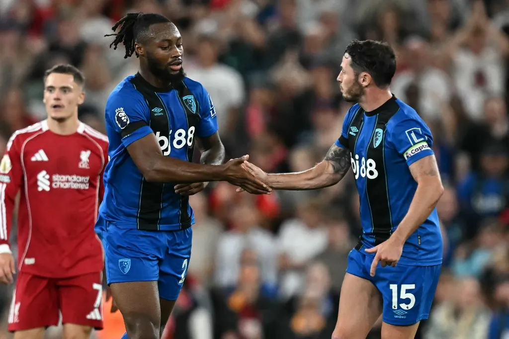 Bournemouth's Ghanaian striker #24 Antoine Semenyo (L) celebrates with Bournemouth's English defender #15 Adam Smith (R) after scoring their first goal during the English Premier League football match between Liverpool and Bournemouth at Anfield in Liverpool, north west England on August 15, 2025. (Photo by Paul ELLIS / AFP) / RESTRICTED TO EDITORIAL USE. No use with unauthorized audio, video, data, fixture lists, club/league logos or 'live' services. Online in-match use limited to 120 images. An additional 40 images may be used in extra time. No video emulation. Social media in-match use limited to 120 images. An additional 40 images may be used in extra time. No use in betting publications, games or single club/league/player publications. / 