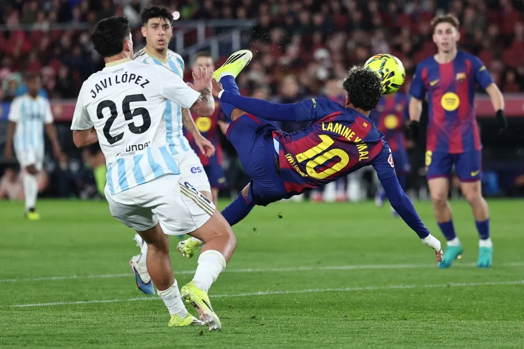 Barcelona's Spanish forward #10 Lamine Yamal scores his team's third goal during the Spanish league football match between FC Barcelona and Real Oviedo at Camp Nou Stadium in Barcelona on January 25, 2026. (Photo by Josep LAGO / AFP)