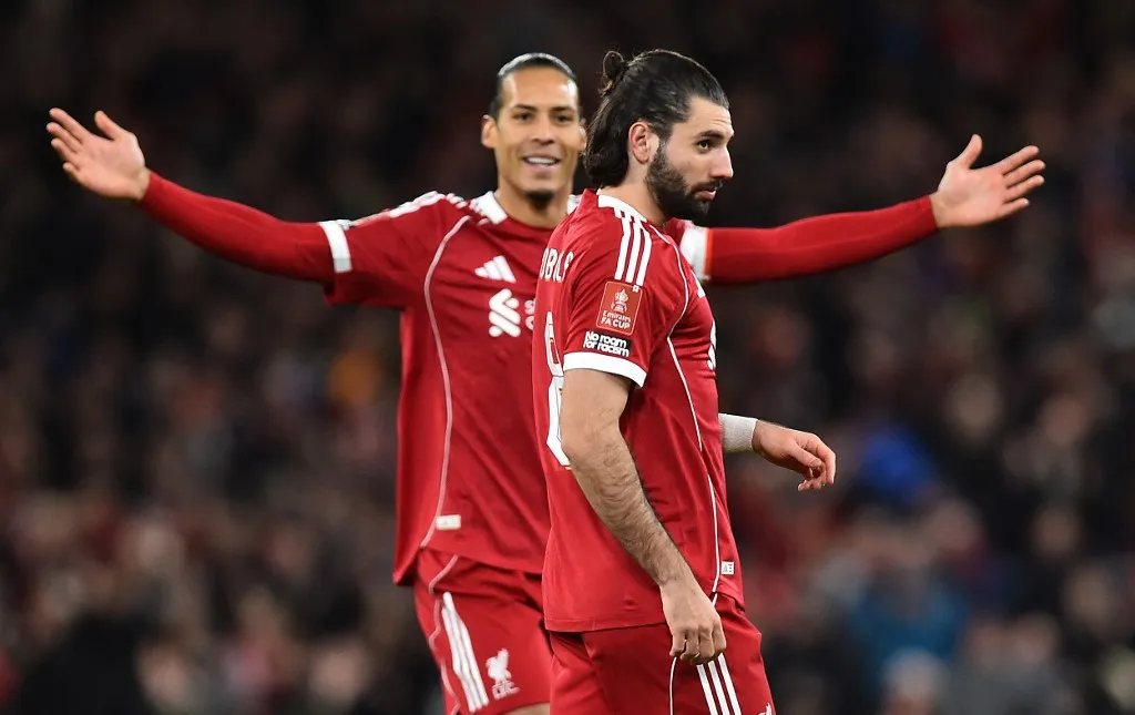 Liverpool's Hungarian midfielder #08 Dominik Szoboszlai (R) celebrates scoring the opening goal during the English FA Cup third round football match between Liverpool and Barnsley at Anfield in Liverpool, north west England on January 12, 2026. (Photo by PETER POWELL / AFP) / RESTRICTED TO EDITORIAL USE. No use with unauthorized audio, video, data, fixture lists, club/league logos or 'live' services. Online in-match use limited to 120 images. An additional 40 images may be used in extra time. No video emulation. Social media in-match use limited to 120 images. An additional 40 images may be used in extra time. No use in betting publications, games or single club/league/player publications. /