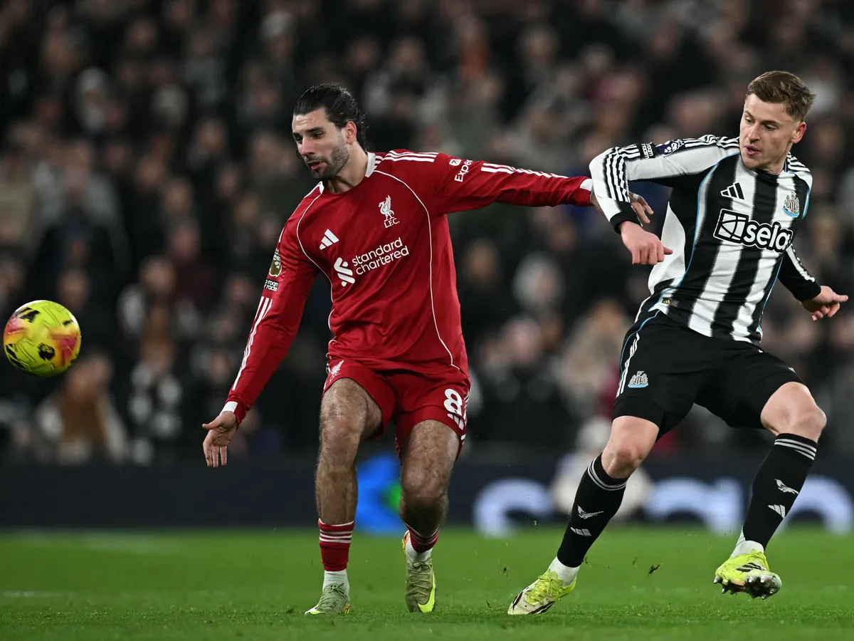 Liverpool's Hungarian midfielder #08 Dominik Szoboszlai (L) vies with Newcastle United's English midfielder #11 Harvey Barnes (R) during the English Premier League football match between Liverpool and Newcastle United at Anfield in Liverpool, north west England on January 31, 2026. (Photo by Paul ELLIS / AFP) / RESTRICTED TO EDITORIAL USE. No use with unauthorized audio, video, data, fixture lists, club/league logos or 'live' services. Online in-match use limited to 120 images. An additional 40 images may be used in extra time. No video emulation. Social media in-match use limited to 120 images. An additional 40 images may be used in extra time. No use in betting publications, games or single club/league/player publications. /