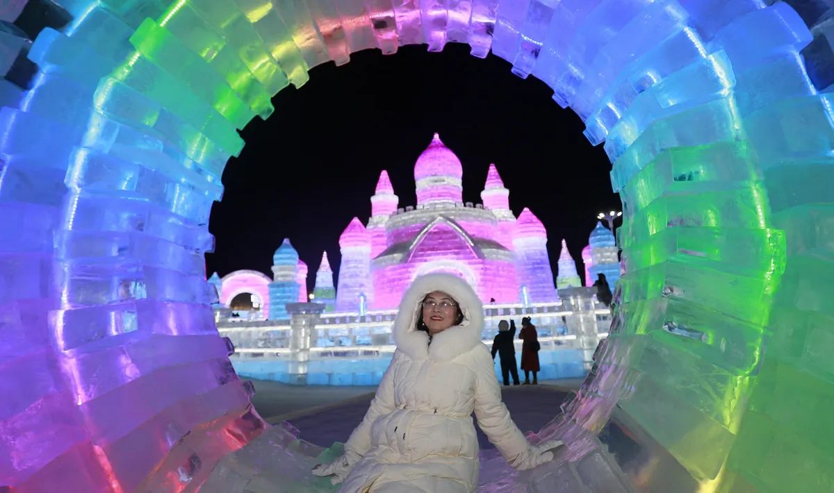 Tourists visit the Harbin Ice and Snow World during the peak ice-snow tourism season in Harbin City, northeast China's Heilongjiang Province, 4 January, 2026. (Photo by Zhang Shu / IC photo / Imaginechina via AFP)