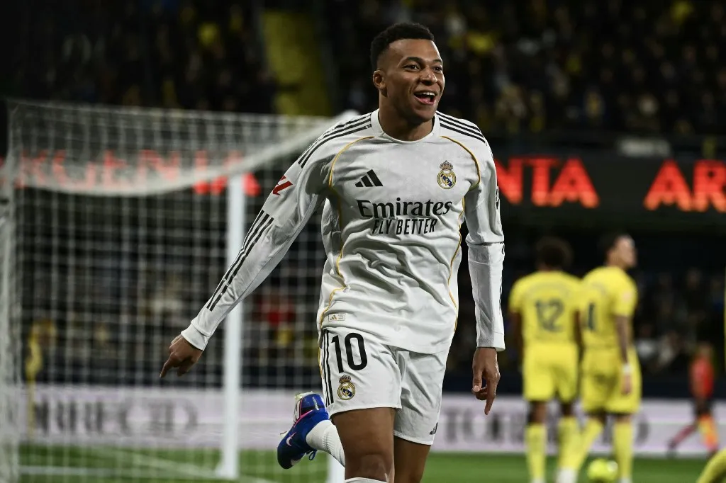 Real Madrid's French forward #10 Kylian Mbappe celebrates scoring his team's first goal during the Spanish league football match between Villarreal CF and Real Madrid CF at La Ceramica Stadium in Vila-Real on January 24, 2026. (Photo by JOSE JORDAN / AFP)