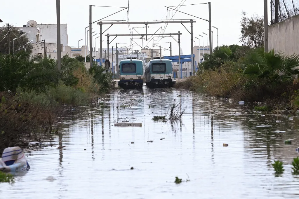 Trains are blocked by floodwaters, in La Goulette near the capital Tunis, on Januray 20, 2026. Flooding across Tunisia has killed three people, authorities said January 20, with one official reporting a "critical" situation as parts of the North African country experienced their heaviest rainfall in more than 70 years. (Photo by FETHI BELAID / AFP)