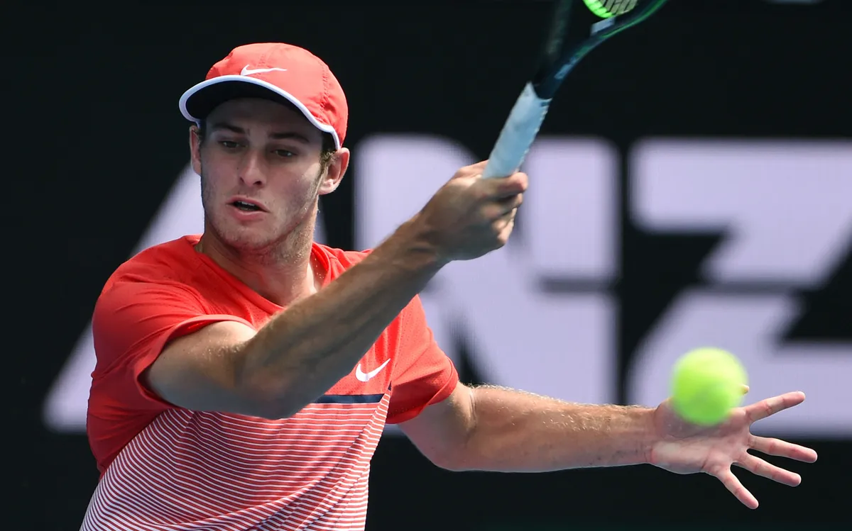 Australia's Oliver Anderson plays a backhand return during his boys singles final match against Uzbekistan's Jurabeck Karimov on day thirteen of the 2016 Australian Open tennis tournament in Melbourne on January 30, 2016. AFP PHOTO / WILLIAM WEST-- IMAGE RESTRICTED TO EDITORIAL USE - STRICTLY NO COMMERCIAL USE (Photo by WILLIAM WEST / AFP)