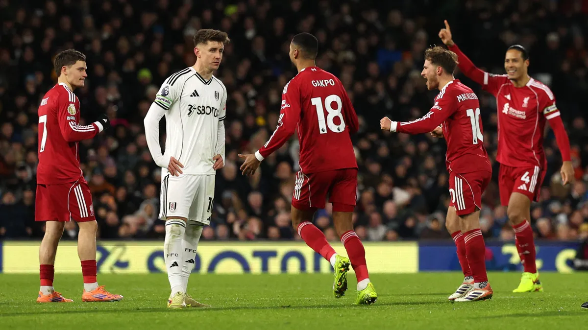 Liverpool's German midfielder #07 Florian Wirtz (L) celebrates with teammates after VAR overturned the offside decision for Liverpool's first goal to equalise 1-1 during the English Premier League football match between Fulham and Liverpool at Craven Cottage in London on January 4, 2026. (Photo by Adrian Dennis / AFP) / RESTRICTED TO EDITORIAL USE. No use with unauthorized audio, video, data, fixture lists, club/league logos or 'live' services. Online in-match use limited to 120 images. An additional 40 images may be used in extra time. No video emulation. Social media in-match use limited to 120 images. An additional 40 images may be used in extra time. No use in betting publications, games or single club/league/player publications. / 