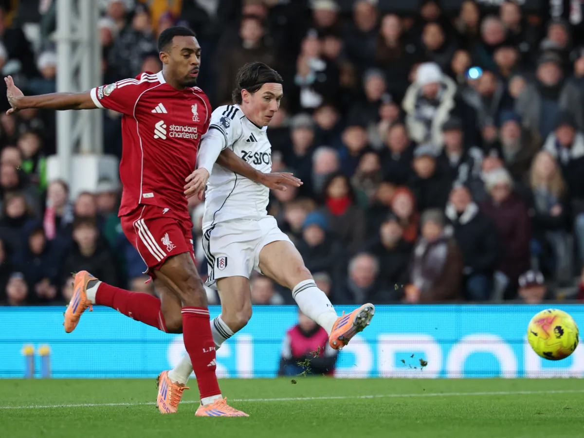 Fulham's Welsh midfielder #08 Harry Wilson (R) scores the opening goal to take the lead 1-0 during the English Premier League football match between Fulham and Liverpool at Craven Cottage in London on January 4, 2026. (Photo by Adrian Dennis / AFP) / RESTRICTED TO EDITORIAL USE. No use with unauthorized audio, video, data, fixture lists, club/league logos or 'live' services. Online in-match use limited to 120 images. An additional 40 images may be used in extra time. No video emulation. Social media in-match use limited to 120 images. An additional 40 images may be used in extra time. No use in betting publications, games or single club/league/player publications. / 