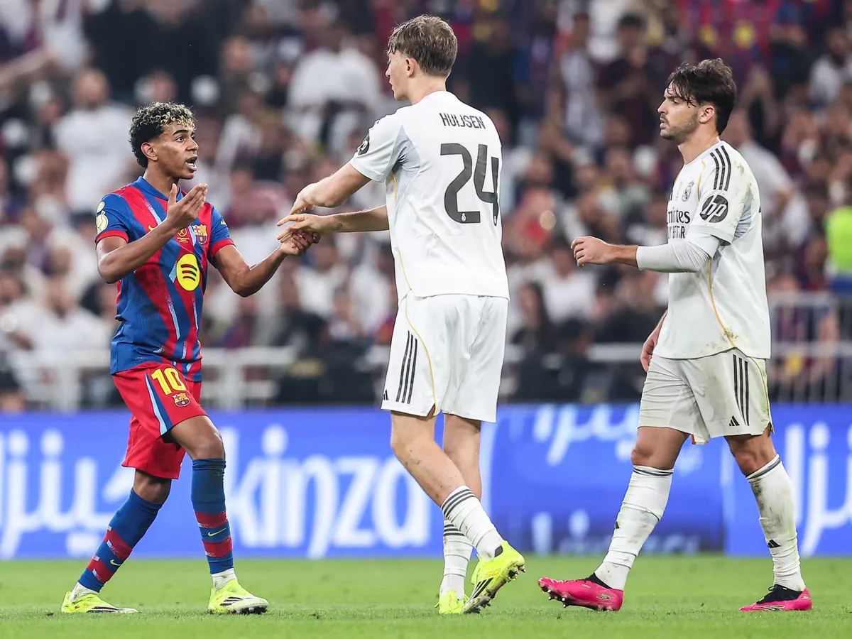Barcelona's Spanish forward #10 Lamine Yamal (L) reacts during the Spanish Super Cup final football match between FC Barcelona and Real Madrid at the King Abdullah Stadium in Jeddah on January 11, 2026. (Photo by Haitham AL-SHUKAIRI / AFP)