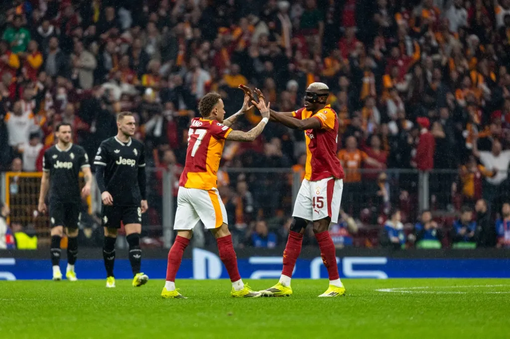 Noah Lang of Galatasaray SK and Victor Osimhen of Galatasaray SK celebrate the goal during the match. Galatasaray SK and Juventus faced each other at UEFA Champions League 2025/26 KO play-offs 1st leg. The match took place in Ali Sami Yen Rams Park Stadium on february 17th, 2026. (Photo by Burak Basturk / Middle East Images via AFP)