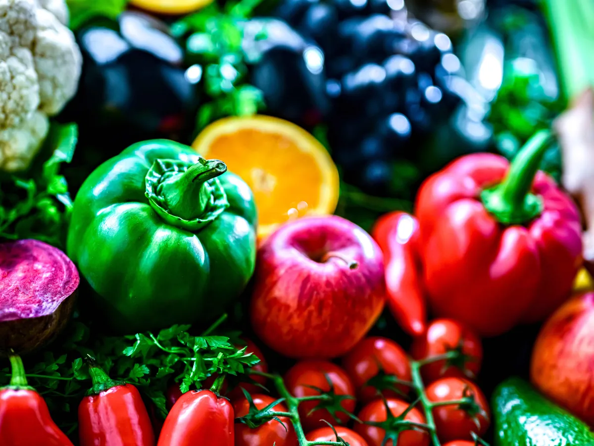 Fresh raw vegetables and fruits. Ingredients of vegan diet.