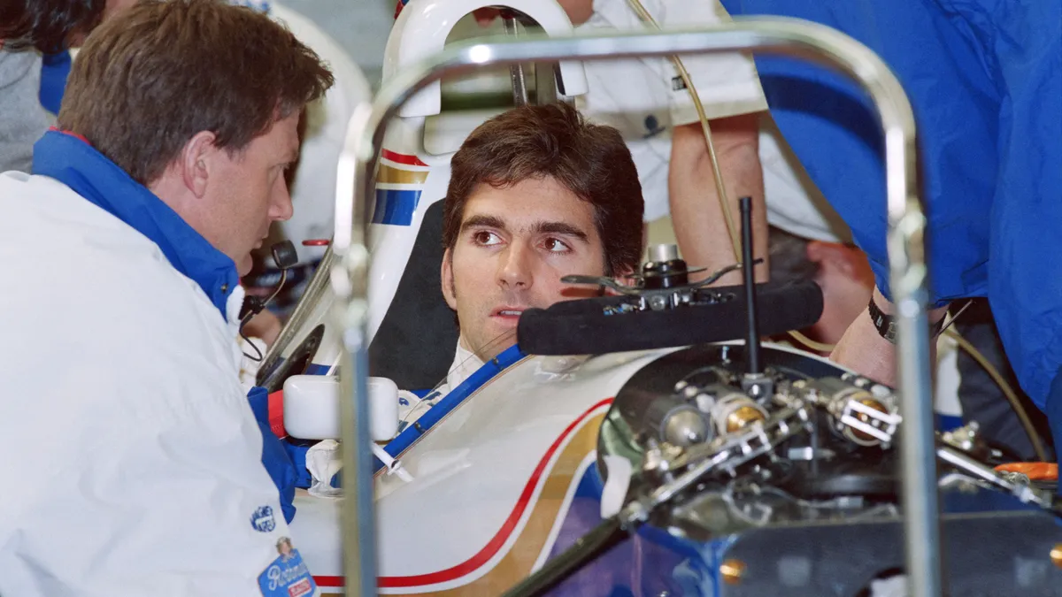 British Williams-Renault driver Damon Hill (C) talks to an unidentified engineer from his team in the pits of the Paul-Ricard circuit in Le Castellet, during William's pratice session, on March 02, 1994. Damon Hill remained in Williams-Renault until 1996, the year he won his first and only Formula One Championship's title, after finishing second behind his great rival, Michael Schumacher, both in 1994 and 1995. (Photo by Eric CABANIS / AFP)