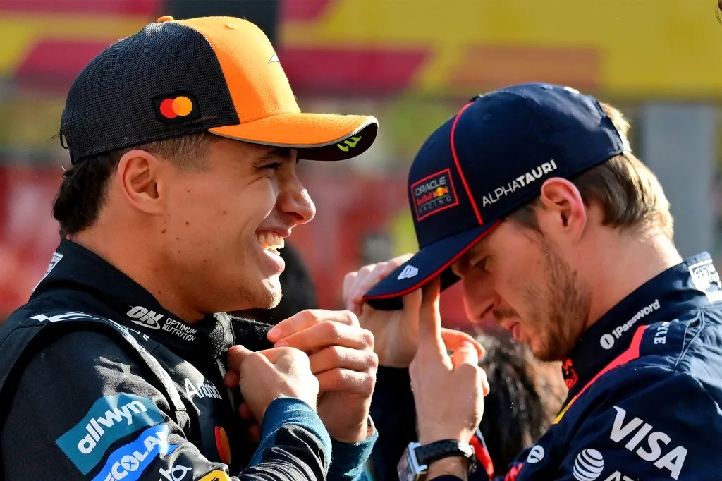 McLaren's British driver Lando Norris and Red Bull Racing's Dutch driver Max Verstappen stand on the grid ahead of the Abu Dhabi Formula One Grand Prix at the Yas Marina Circuit in Abu Dhabi on December 7, 2025. (Photo by Andrej ISAKOVIC / AFP)