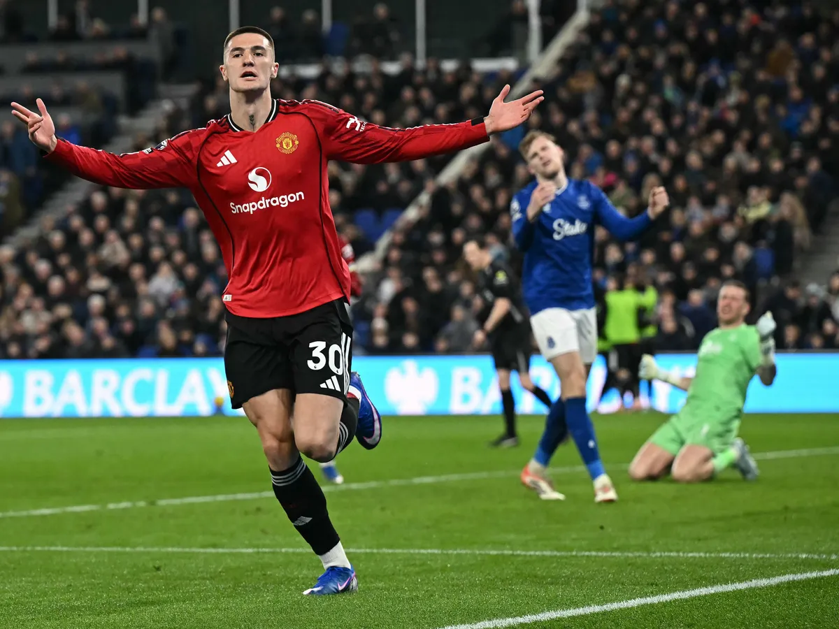 Manchester United's Slovenian striker #30 Benjamin Sesko celebrates scoring the opening goal during the English Premier League football match between Everton and Manchester United at the Hill Dickinson Stadium in Liverpool, north west England on February 23, 2026. (Photo by Paul ELLIS / AFP) / RESTRICTED TO EDITORIAL USE. No use with unauthorized audio, video, data, fixture lists, club/league logos or 'live' services. Online in-match use limited to 120 images. An additional 40 images may be used in extra time. No video emulation. Social media in-match use limited to 120 images. An additional 40 images may be used in extra time. No use in betting publications, games or single club/league/player publications. / 